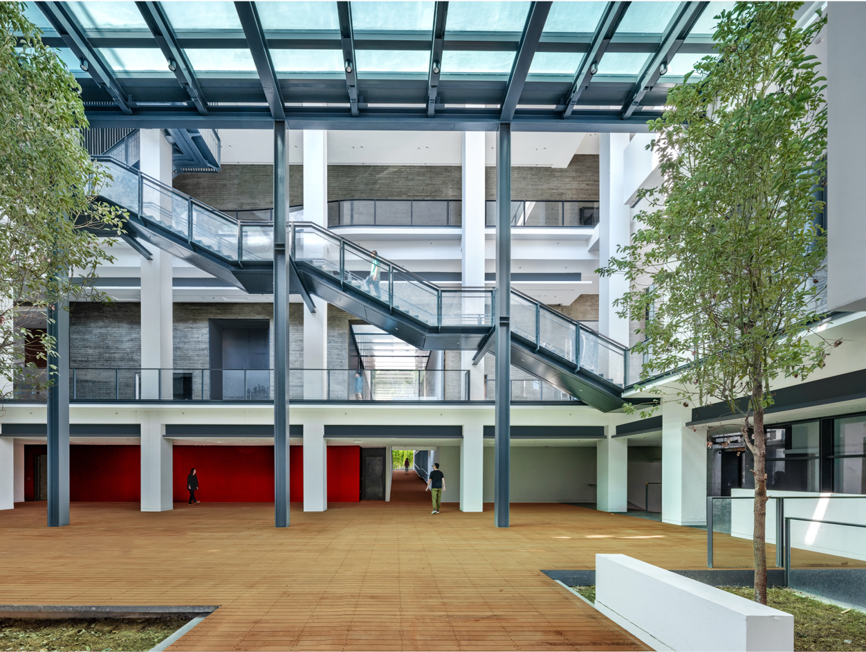 The glass floor on top of the central courtyard provides natural light into the public gathering place