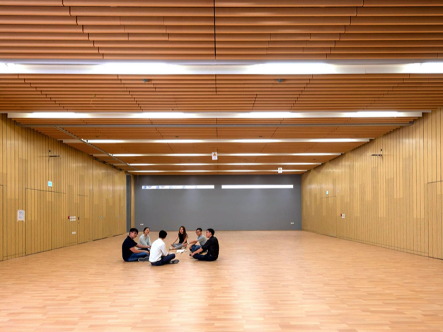 A large indoor activity room that is adjacent to the inverted cone, providing areas for organising different community activities and social gathering